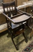 An early 20th century oak and beech child's metamorphic high chair