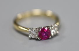 A modern 18ct gold and platinum, ruby and diamond set three stone ring, size M, gross 3.3 grams.