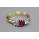 A modern 18ct gold and platinum, ruby and diamond set three stone ring, size M, gross 3.3 grams.