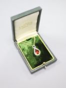 A white and yellow metal, garnet and diamond set teardrop shaped pendant necklace, pendant 29mm,