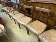 A set of eight George III style Sheraton design mahogany dining chairs, with leather stuff-over