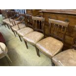 A set of eight George III style Sheraton design mahogany dining chairs, with leather stuff-over