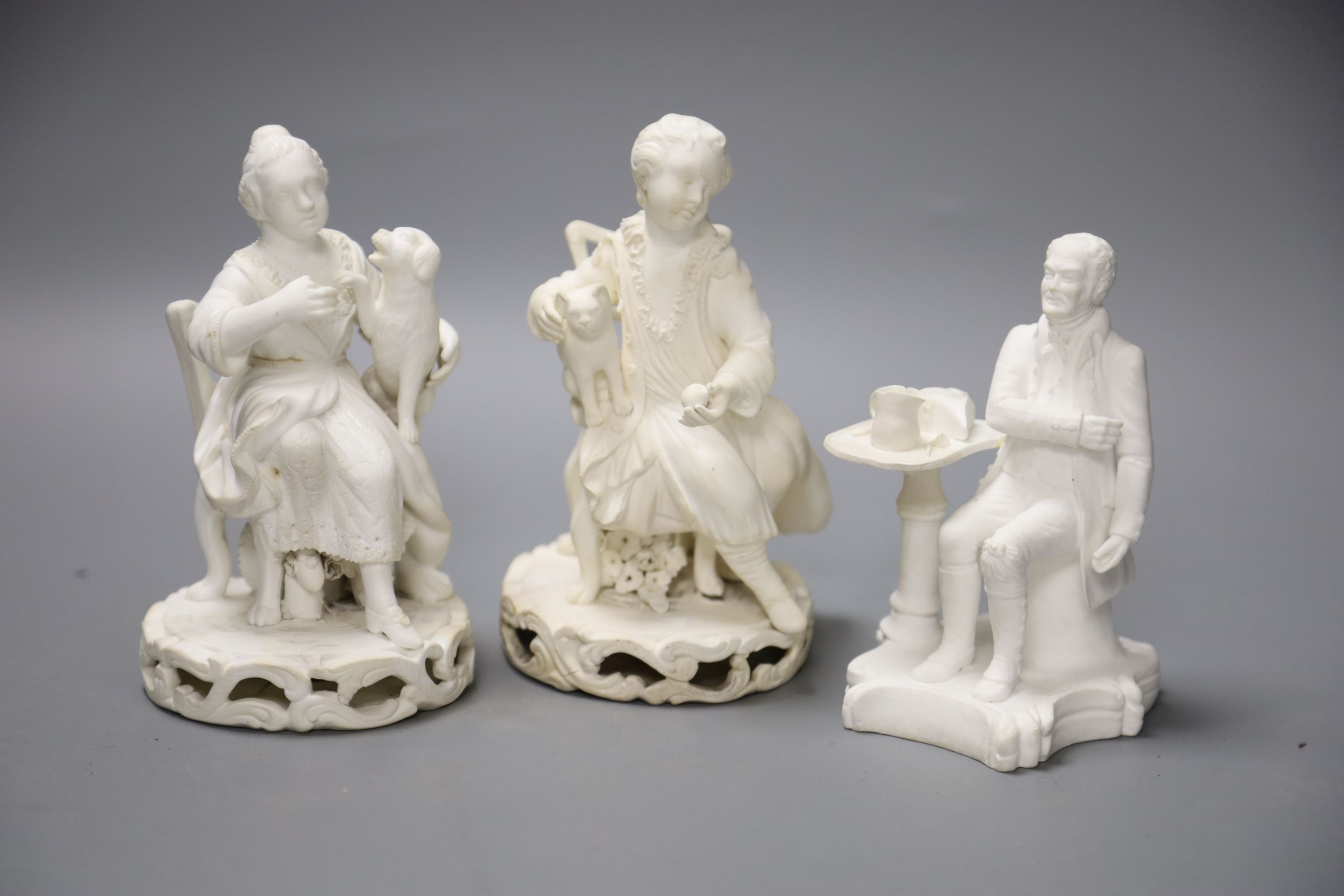 An early 19th century pair of Derby biscuit figures of a boy with a cat and a girl with a dog and