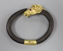 A continental yellow metal and gem set mounted wooden? bangle, with horse head terminal, gross 40