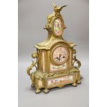 A French gilt metal mantel clock with Sevres-style panels, height 46cm