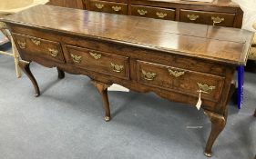 A late 17th century oak dresser base on cabriole front legs, length 180cm, depth 43cm, height 77cm