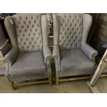 A pair of Victorian style wing armchairs, recently re-upholstered in buttoned grey fabric, width