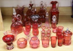 A large collection of cranberry glass