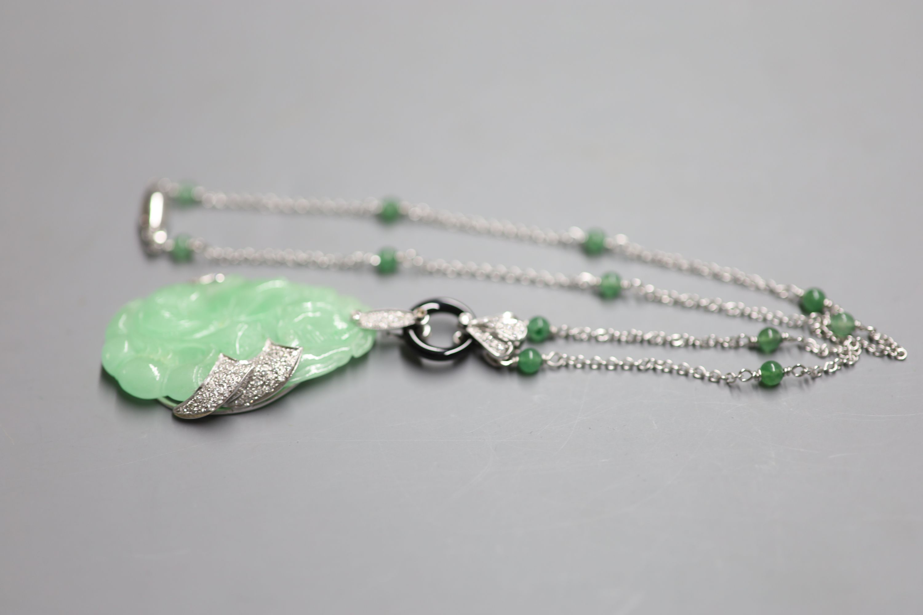 A modern Italian 750 white metal, carved jadeite, black onyx and diamond set pendant necklace, - Image 3 of 3