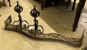 A George III pierced steel serpentine fender, length 130cm, together with a pair of wrought iron