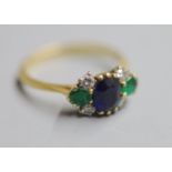 A 1970's 18ct gold, sapphire, emerald and diamond cluster ring, size P/Q, gross 3.2 grams.CONDITION: