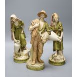 A pair of Royal Dux female water carriers and another of a farmer, 32cm