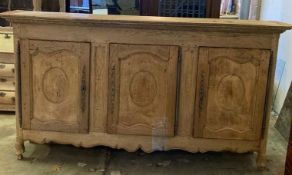 A late 18th century French provincial bleached oak three door buffet, length 244cm, depth 46cm,