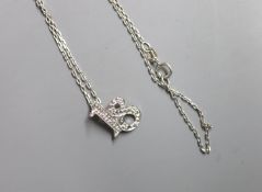 A modern 9ct white gold and diamond chip set '18' pendant, 14mm, on a 9ct white gold fine link