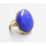 An early 20th century yellow metal and cabochon lapis lazuli set dress ring, size J, gross 8.4 grams