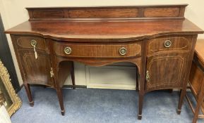 An Edwardian inlaid mahogany serpentine fronted sideboard, length 184cm, depth 68cm, height 112cm