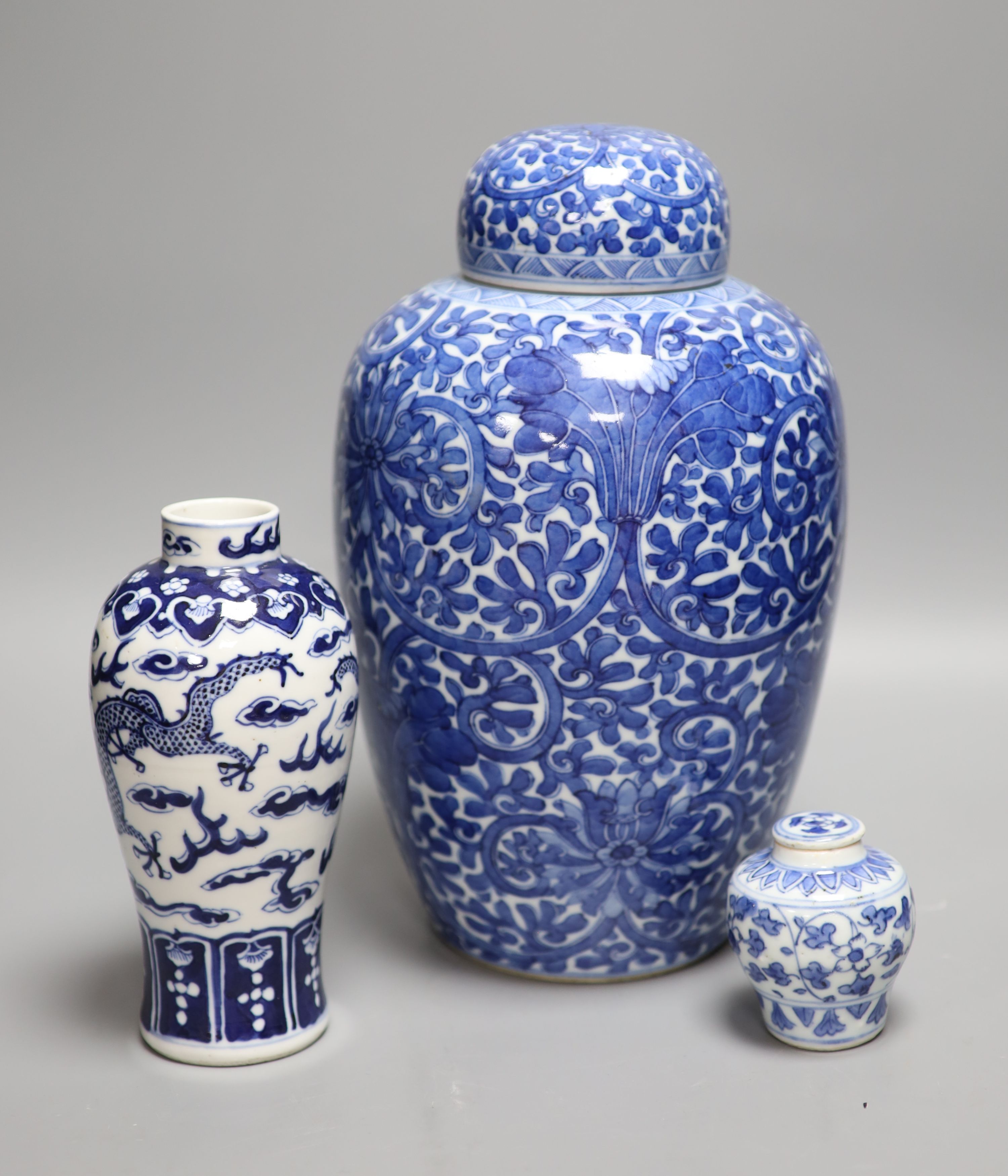 A Chinese blue and white 'lotus' jar and cover, early 20th century, a similar 'dragon' vase and a