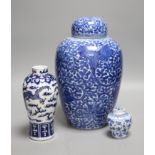 A Chinese blue and white 'lotus' jar and cover, early 20th century, a similar 'dragon' vase and a