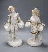 A pair of 19th century bisque gilt painted and decorated figures of a peasant boy and girl