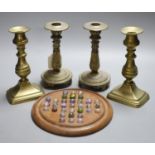 Two pairs of brass candlesticks and a solitaire board with marbles