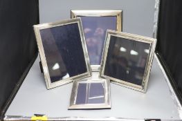Four modern silver photographs frames, two with decorative banding 22.5 x 18cm to 32 x 27cm (