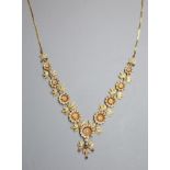 An early to mid 20th century Indian gilt metal, ruby and split pearl floral cluster drop necklace,