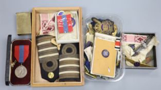 A collection of military medals, badges, coins etc.