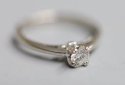 A modern white metal (stamped Plat) and solitaire diamond ring, size N, gross 4 grams, the stone