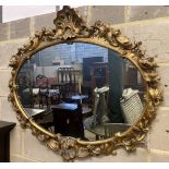 A Victorian ornate gilt oval wall mirror, width 110cm height 100cm