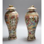 A pair of 19th century Chinese famille rose vases and associated covers, height excl. cover 28cm (