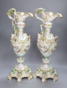 A pair of 19th century German floral and bird painted ewers, height 50cm
