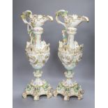 A pair of 19th century German floral and bird painted ewers, height 50cm