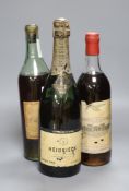 A 1915 bottle of Heidsieck, a bottle of Barsac and a K.P. Charente brandy by Peters Hall & Co,