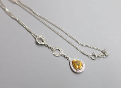 A modern 9ct white gold, pear shaped citrine and diamond chip cluster drop pendant, 47mm, on a 9ct