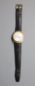 A gentleman's 9ct gold Omega manual wind dress wrist watch, on associated damaged leather strap,