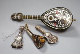 Three miniature tortoiseshell guitars and lute and a larger musical lute