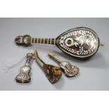 Three miniature tortoiseshell guitars and lute and a larger musical lute