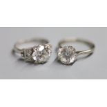 A white metal (stamped plat) single stone moissanite? and four stone diamond set dress ring, size M,