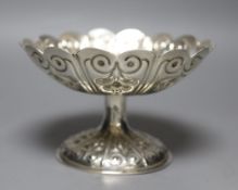 An Edwardian embossed silver circular pedestal dish of lobed form, George Nathan & Ridley Hayes,