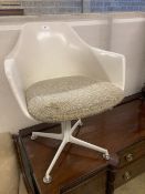 A mid century design moulded plastic swivel chair, with four prong base, width 62cm depth 50cm