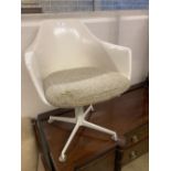 A mid century design moulded plastic swivel chair, with four prong base, width 62cm depth 50cm