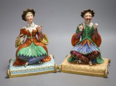 A pair of Jacob Petit mid 19th century scent bottles modelled as Ottoman Turkish seated figures,