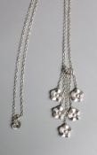 A modern 9ct white gold quintuple flower head cluster drop pendant, 40mm, on a 9ct white gold chain,