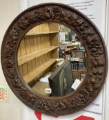 A carved wood circular wall mirror, diameter 56cm