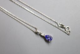 A modern 9ct white gold, tanzanite and diamond chip set drop pendant, 10mm, on a 9ct white gold fine