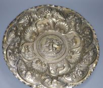 A Continental white metal charger, embossed with cherub and animals amid foliage, 44cm, 28oz, (a.