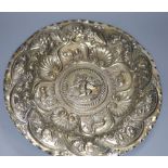 A Continental white metal charger, embossed with cherub and animals amid foliage, 44cm, 28oz, (a.