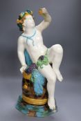 A majolica pottery figure of Bacchus, height 47cm (a.f.)