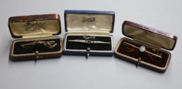 Three assorted Edwardian and later yellow metal bar brooches including a sapphire and seed pearl,