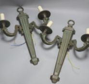 A pair of bronze two branch wall lights, length 52cm